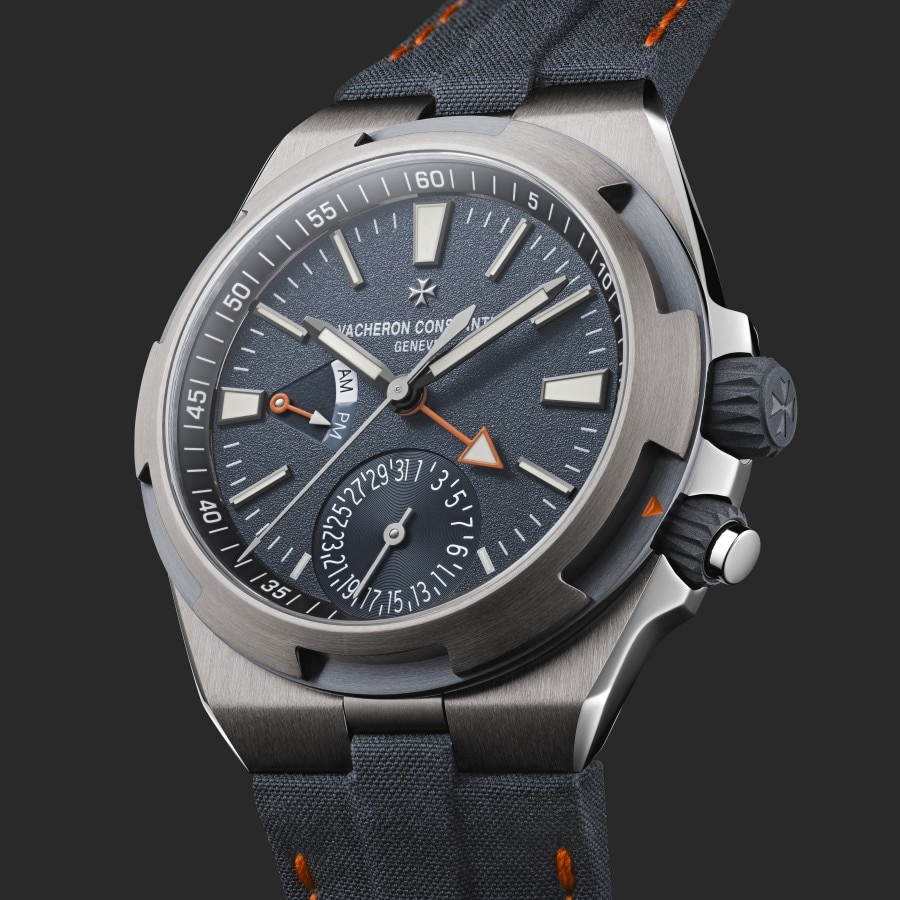Primo piano di un orologio cronografo Vacheron Constantin con quadrante nero testurizzato e cinturino in tessuto.