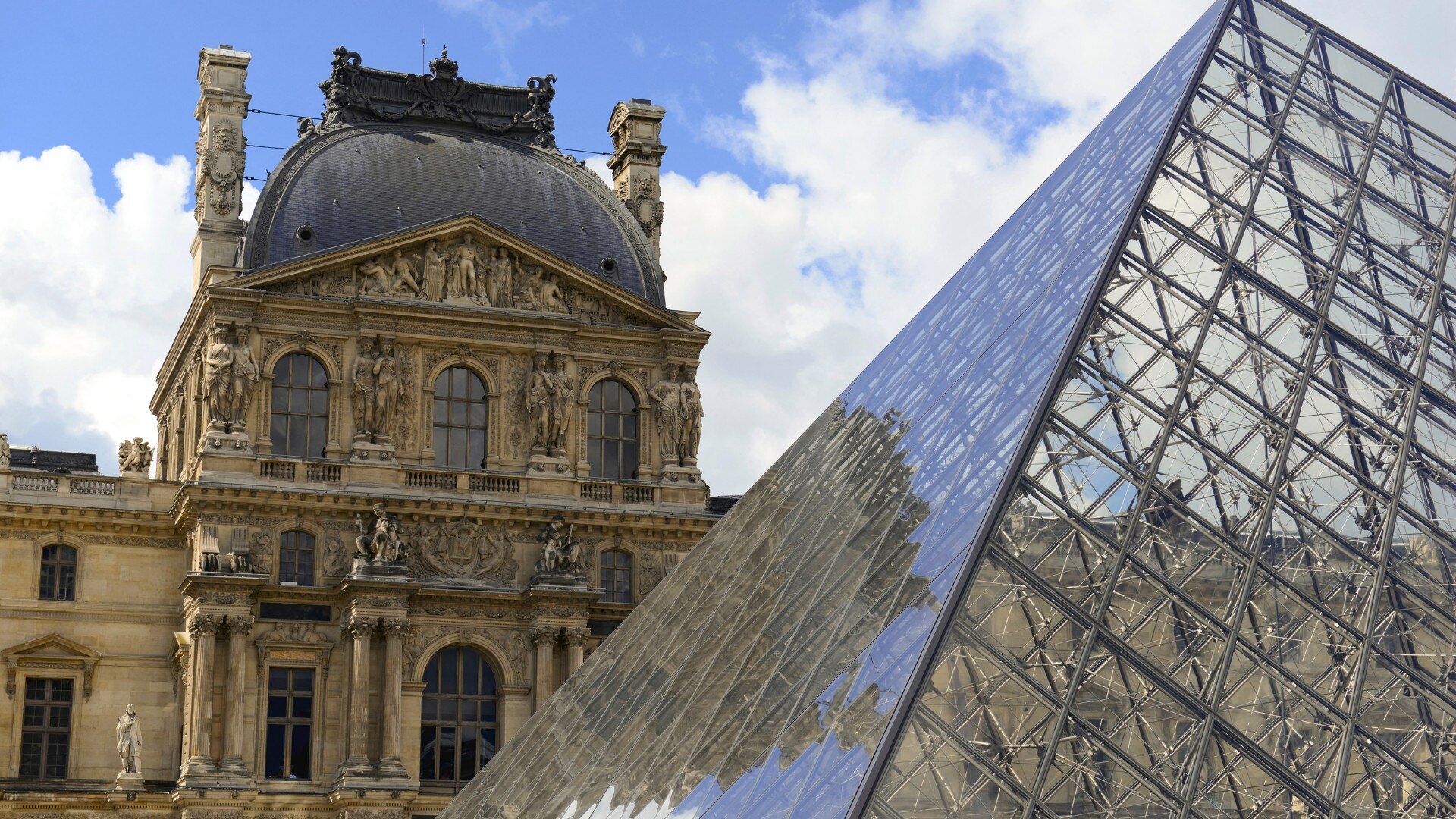 Exterior view of the Louvre Museum with the glass pyramid in Paris.