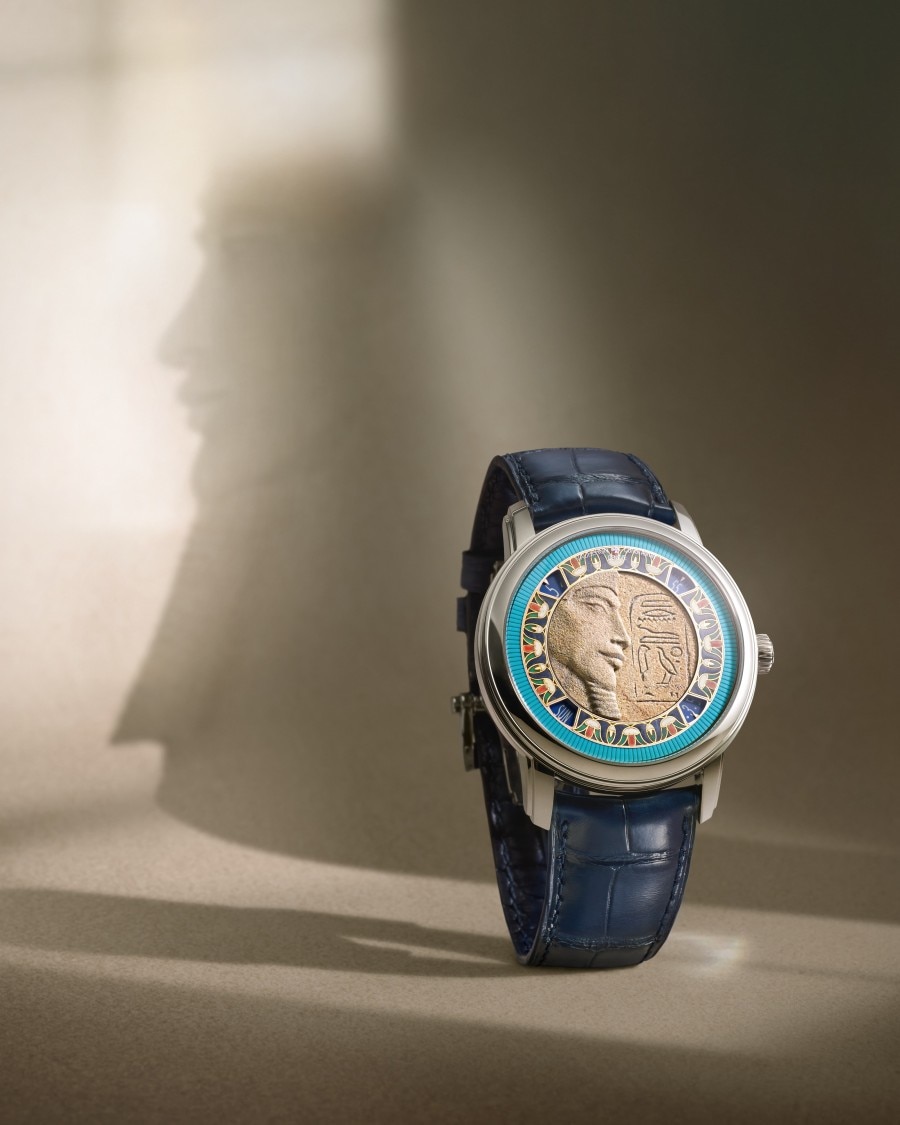 A watch featuring a pharaoh motif in its case on a light background.