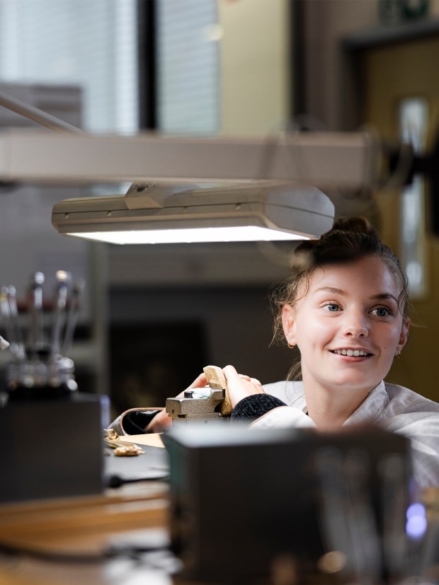 Young Watchmaker working in a modern workshop