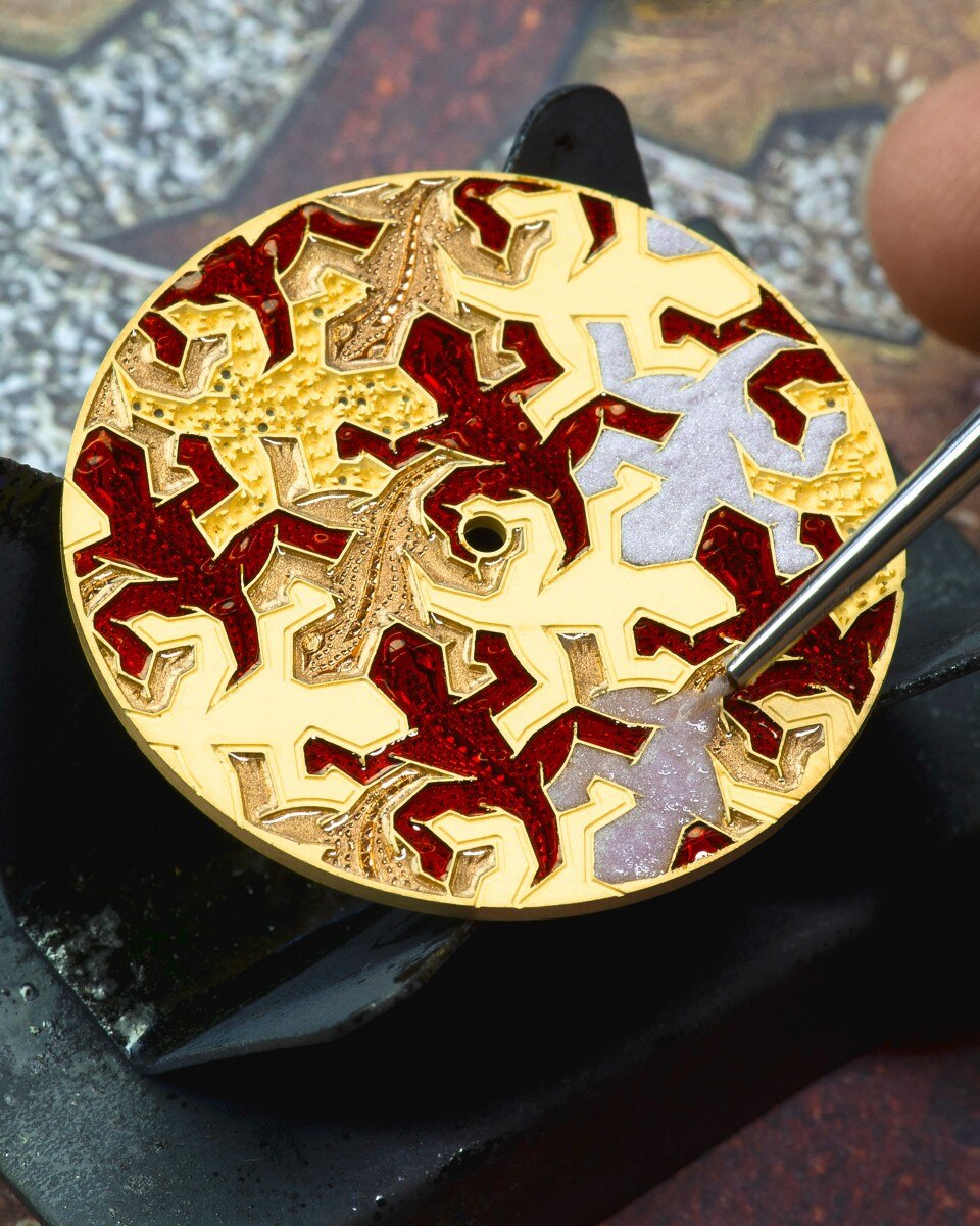 Detailed view of a colorful cloisonne enamel dial with red, yellow, and lilac patterns.