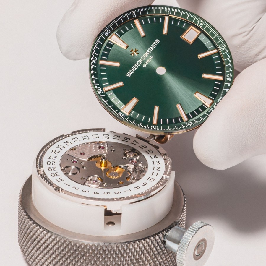 Watchmaker assembling an Overseas watch with a green dial