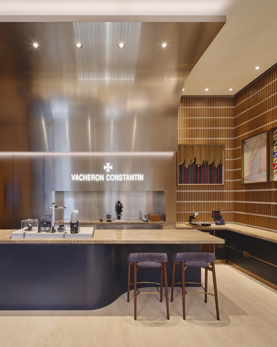 Vacheron Constantin watch showcase featuring the Maltese cross symbol and captivating wall images, with the brand name displayed.