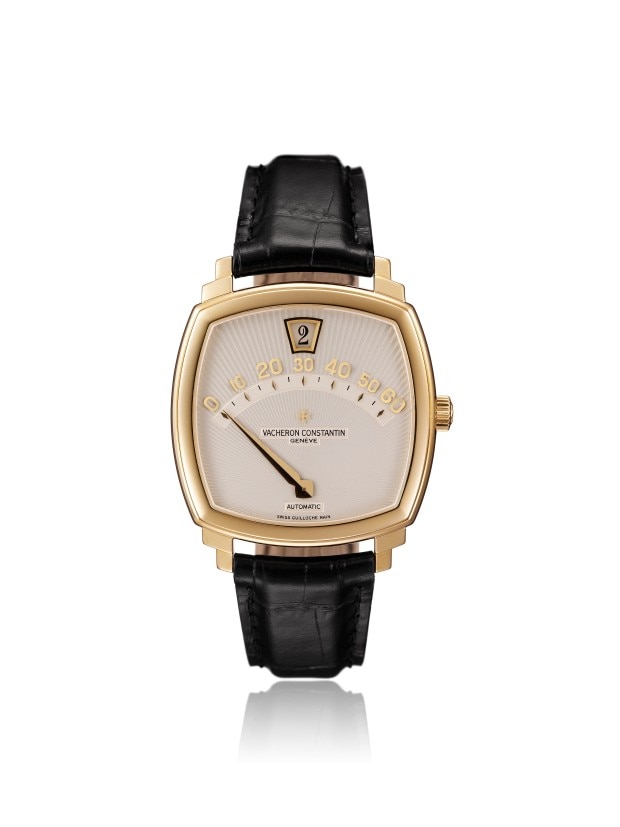 Gold rectangular wirstwatch with a moon phase complication, calendar function and a black leather strap.