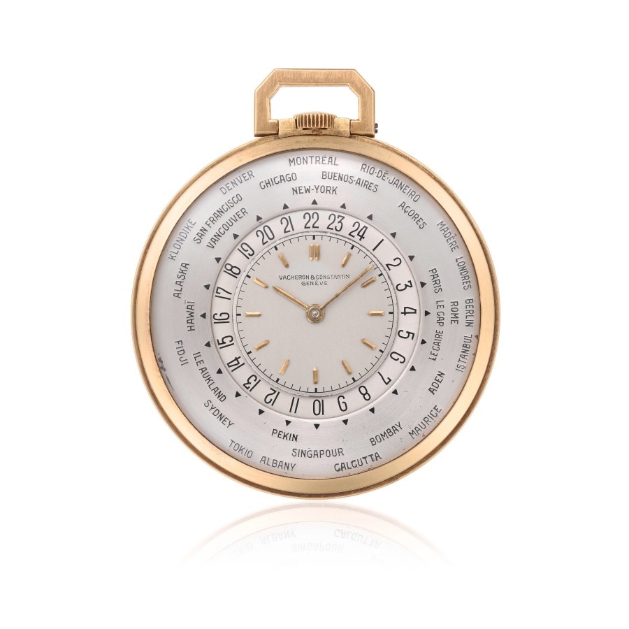 A gold pocket watch displaying multiple time zones