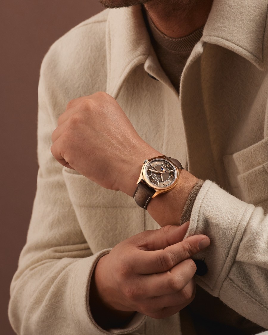 Fiftysix  Fiftysix watch with gold case and brown leather strap.
