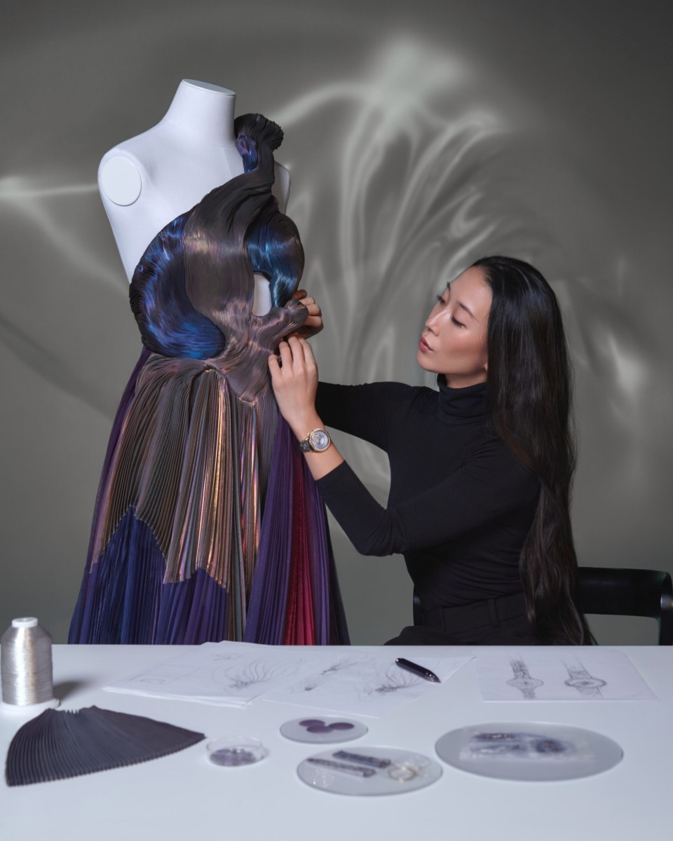 Yiqing Yin works on a beautiful dress.