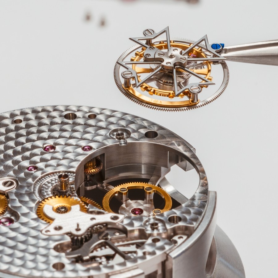Watchmaker assembling components in a caliber