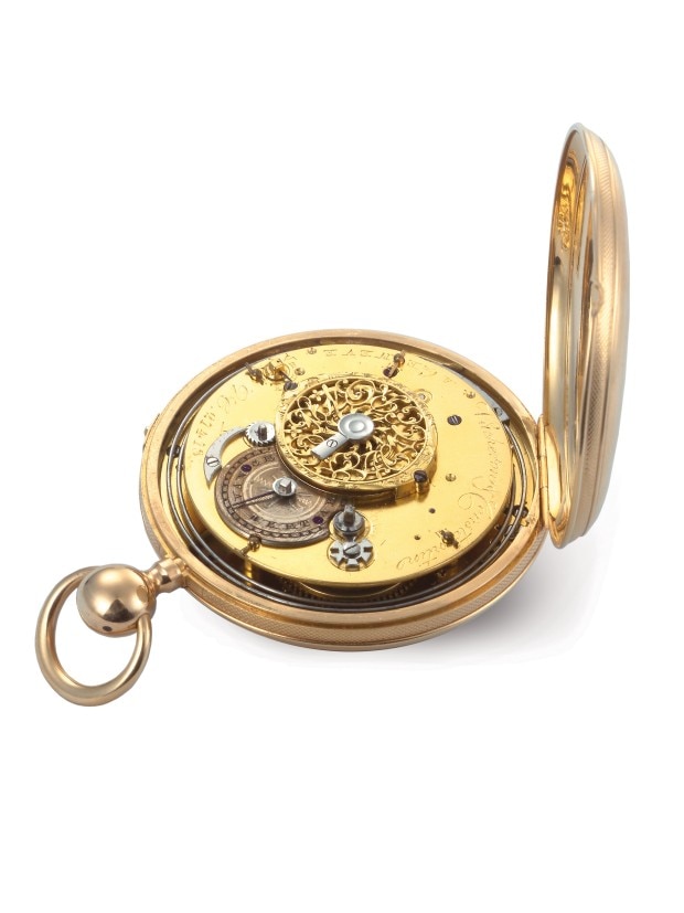 Antique gold pocket watch with an open cover, revealing an intricate mechanical movement with engraved details.
