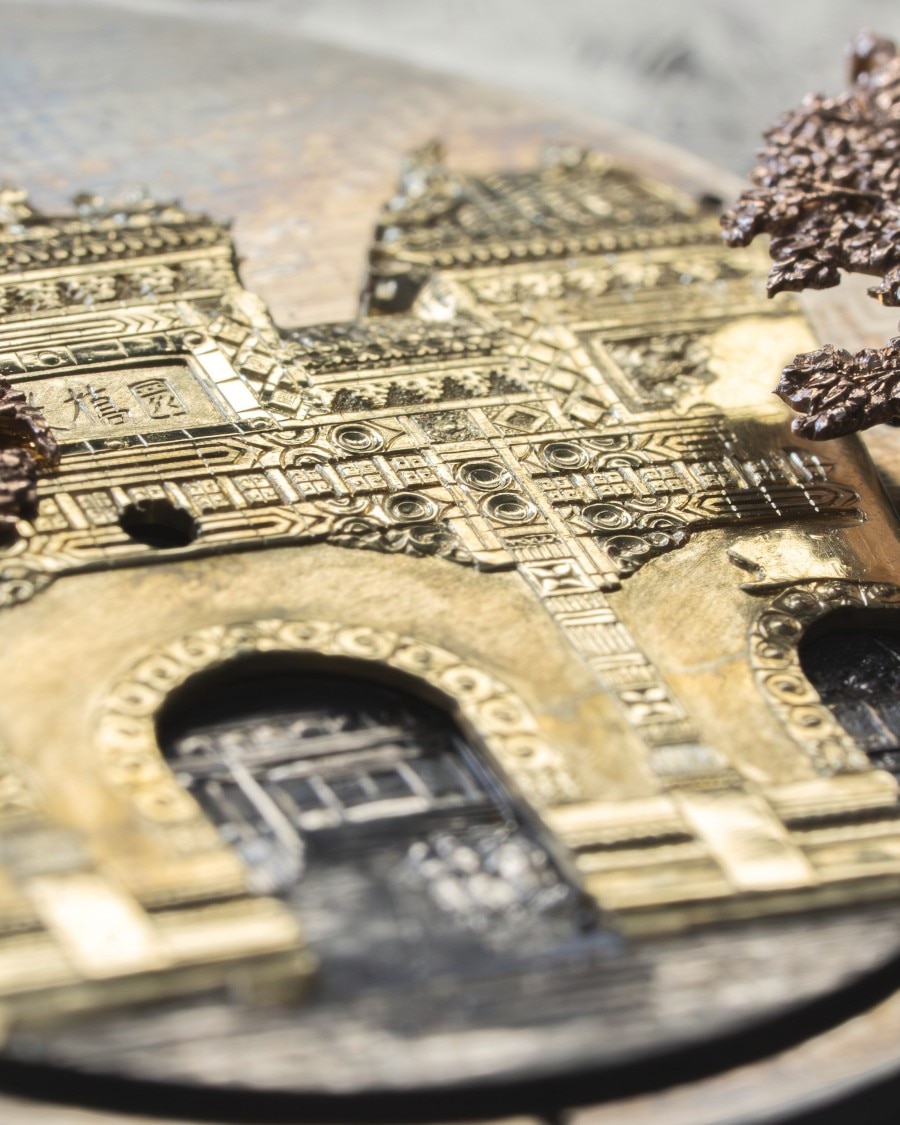 A miniature building engraved to the finest detail for a watch