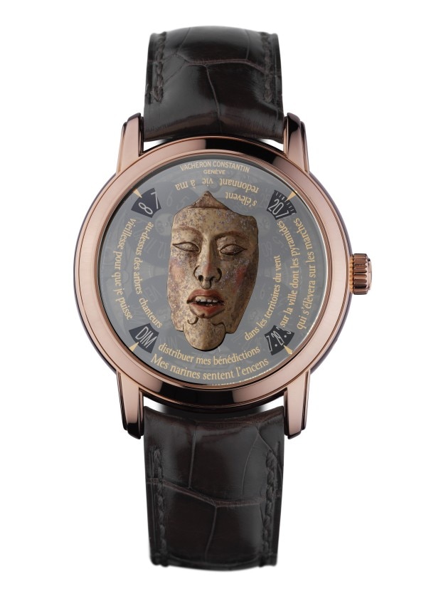 Luxury wirstwatch with an inticrately carved dial featuring a detailed face and text.
