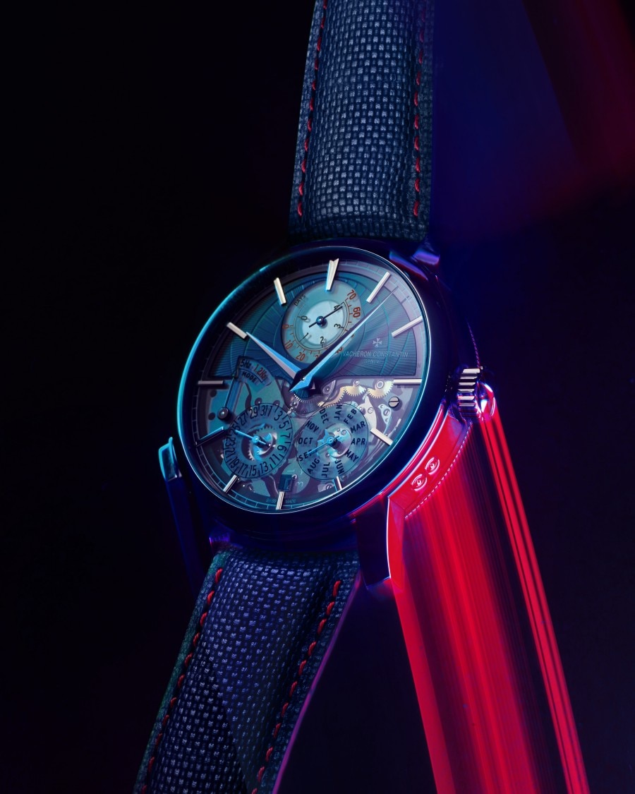 Front view of Traditionnelle Twin Beat perpetual calendar with neon lighting on a dark background.