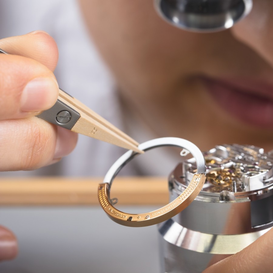 Watchmaker assembling an Overseas watch caliber