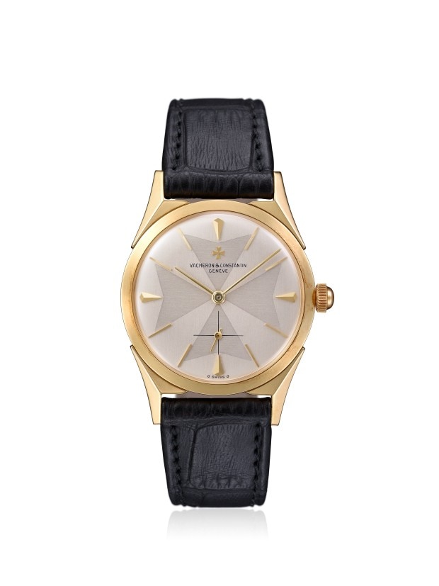 Gold dress watch with a textured sliver dial and black leather strap.