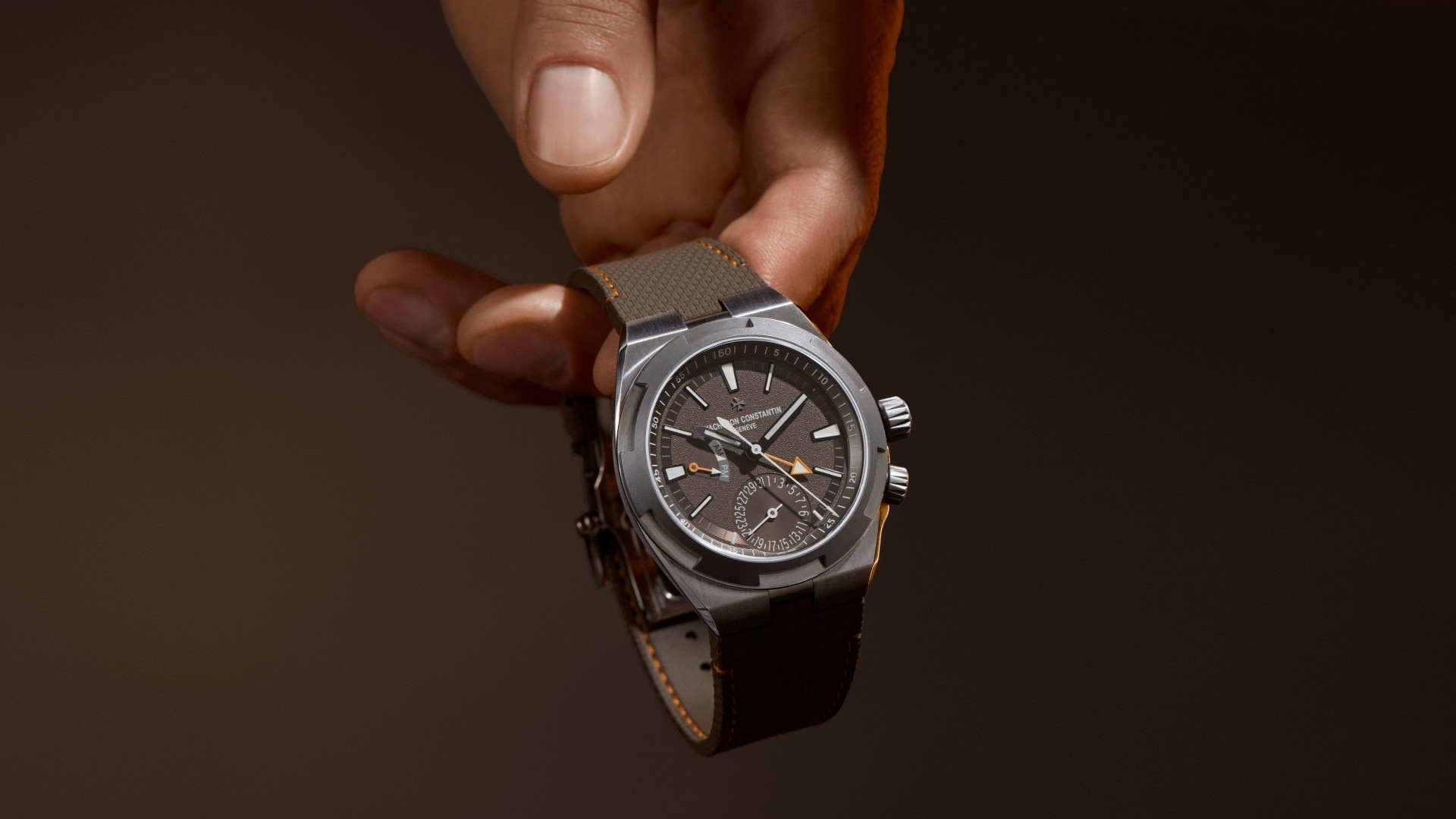 Close-up of a hand holding a luxury Vacheron Constantin watch.