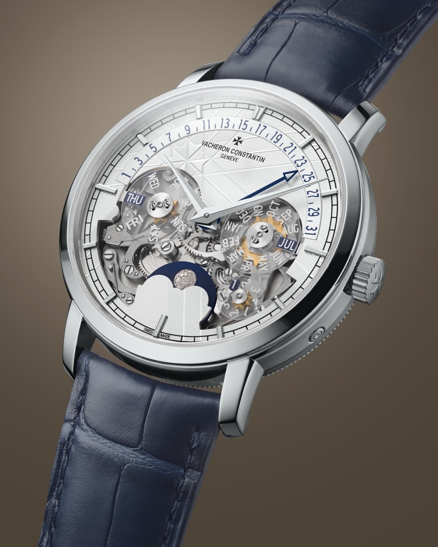 Traditionnelle - Openface Eine stilvolle Uhr mit blauem Lederarmband, silbernem Gehäuse, transparentem Zifferblatt, das das mechanische Uhrwerk freigibt, und zusätzlichen Hilfszifferblättern.