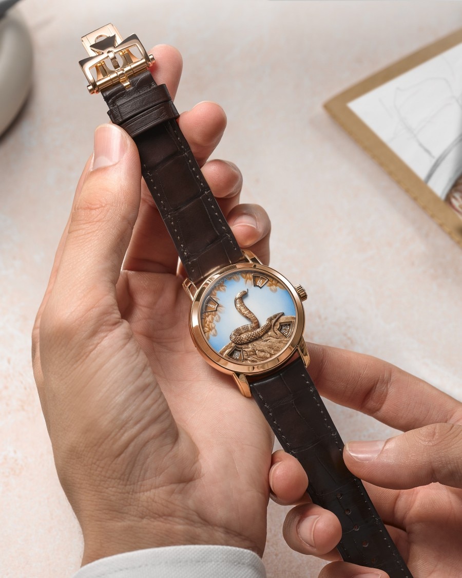 Métiers d'Art Métiers d’Art watch with artistic dial held by hand in white cuff.