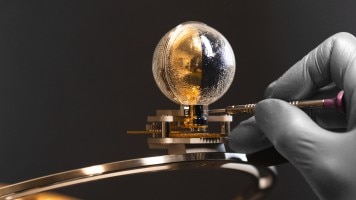 Image illustrating a glove that uses a tool to manipulates the moon in 3D