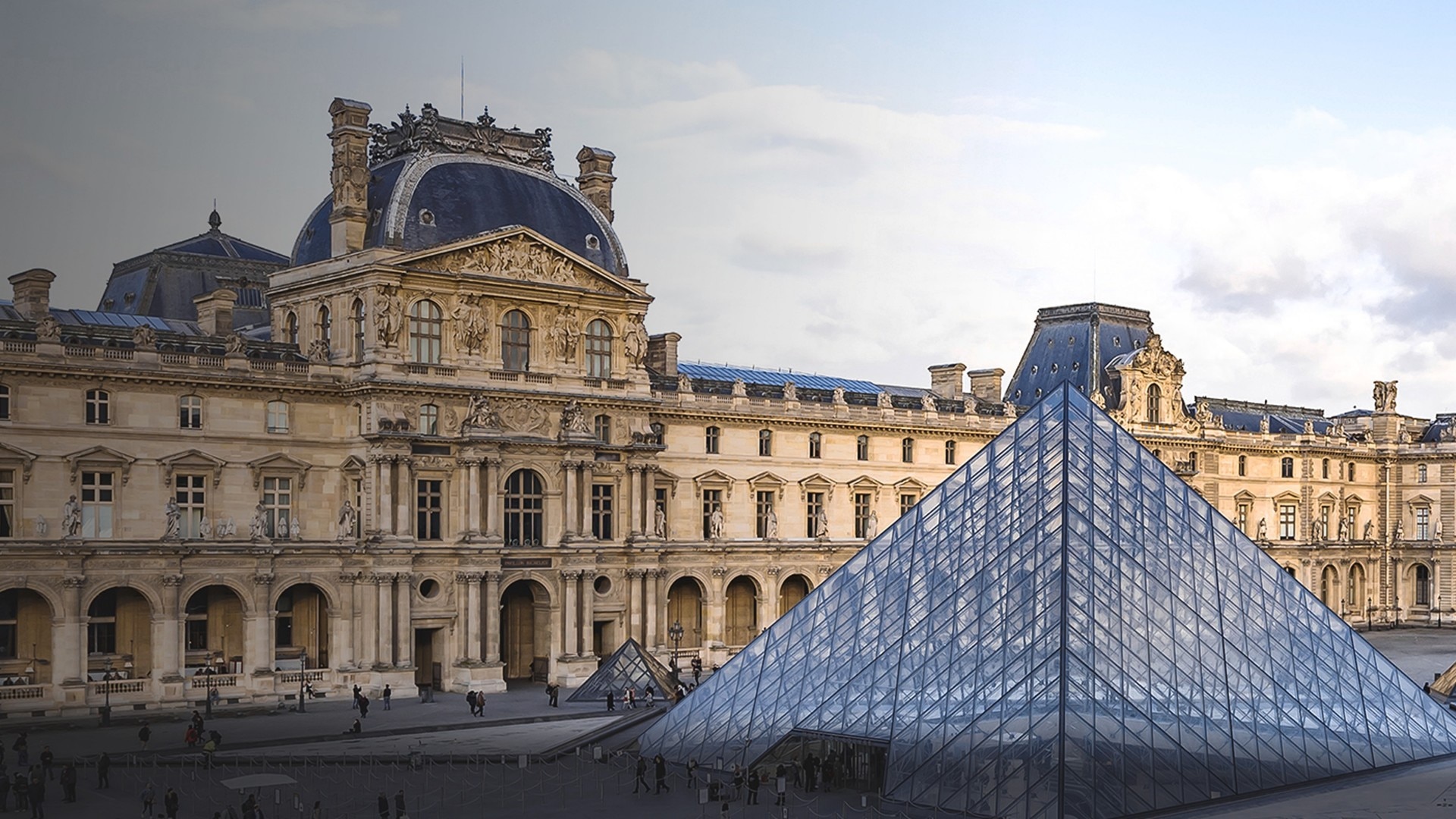 Exterior view of the Louvre Museum with the glass pyramid in Paris.