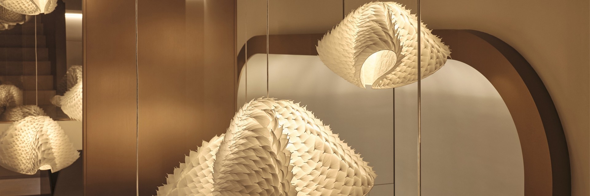 A woven pendant light emitting a warm and soft glow.