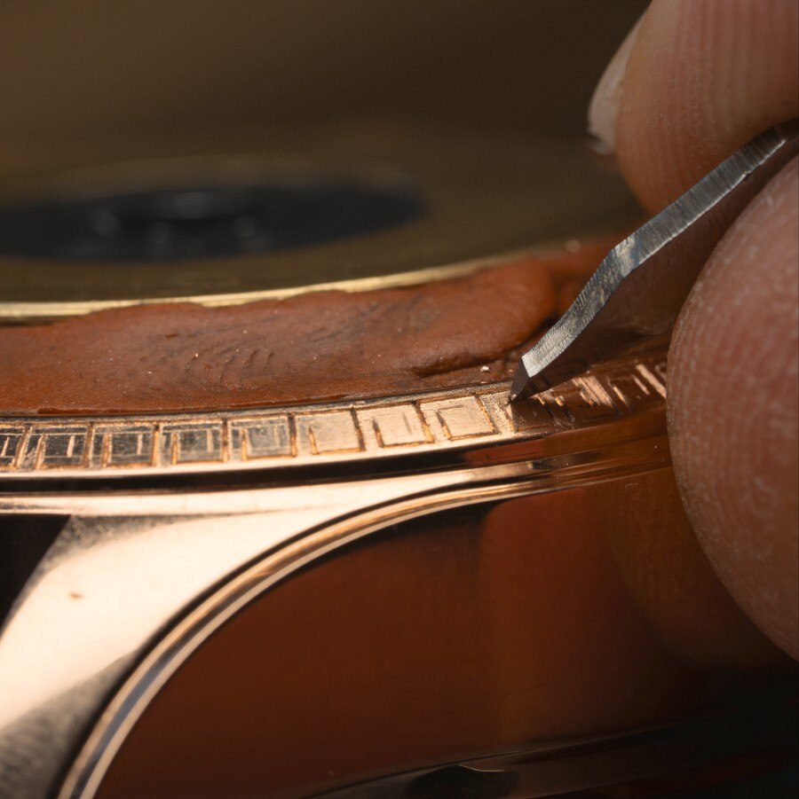 Precise engraving of the gold watch frame
