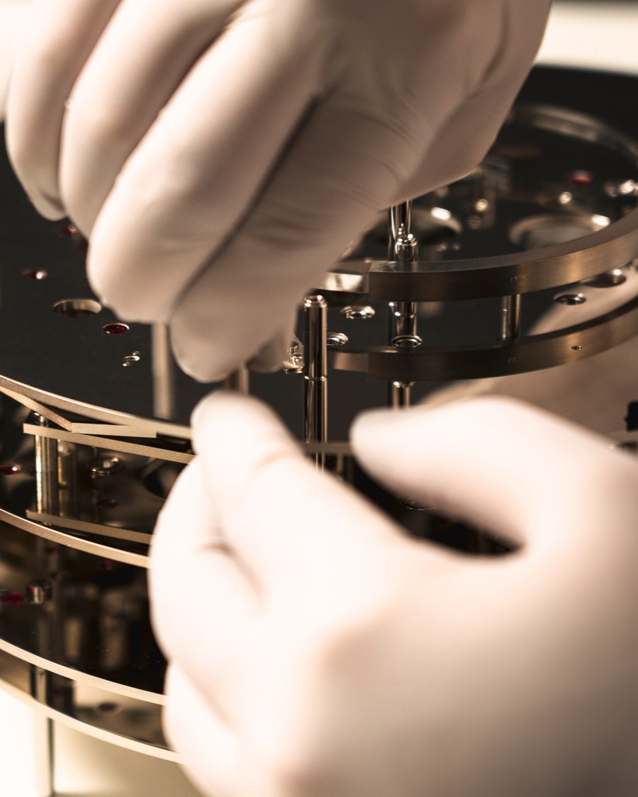 Image illustrating gloves handling a watch
