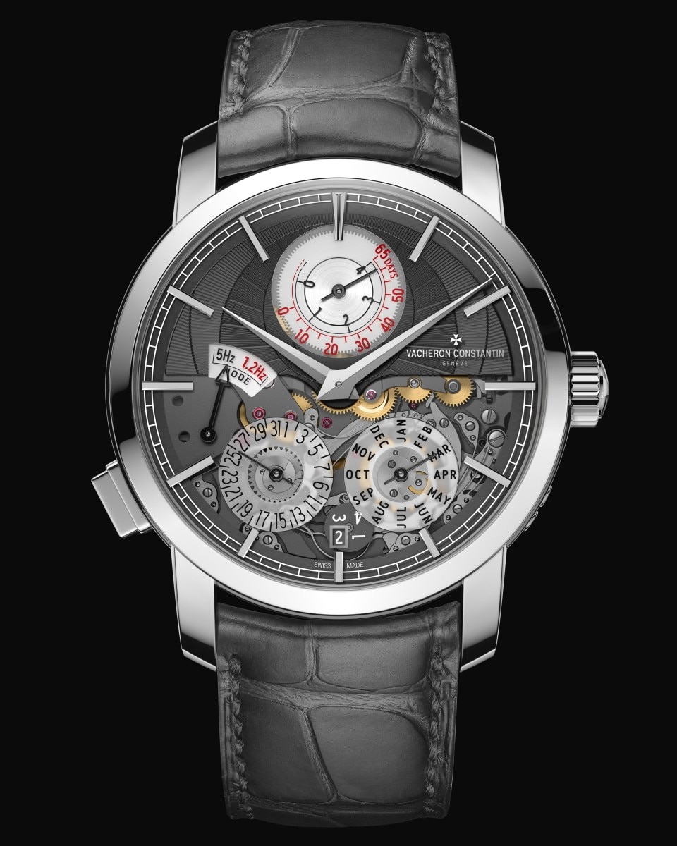 Detailed shot of a luxury watch’s silver dial, open mechanics, and elegant dark leather strap.
