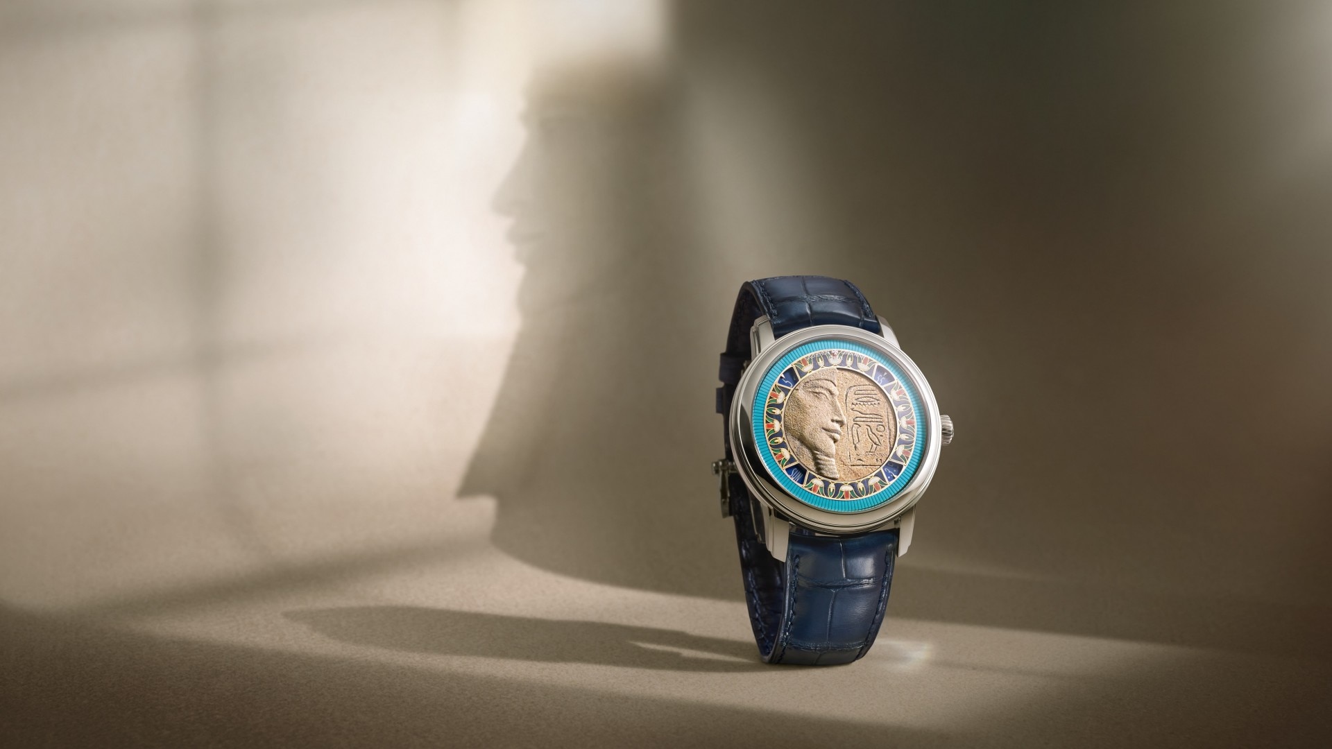 A watch featuring a pharaoh motif in its case on a light background.