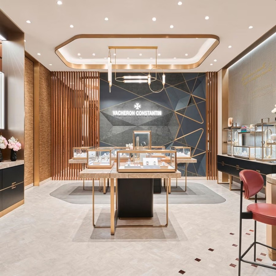 Interior view of a luxury watch boutique with elegant lighting and displayed counters.