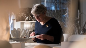 Artist precisely creating a paper crocodile concept watch.