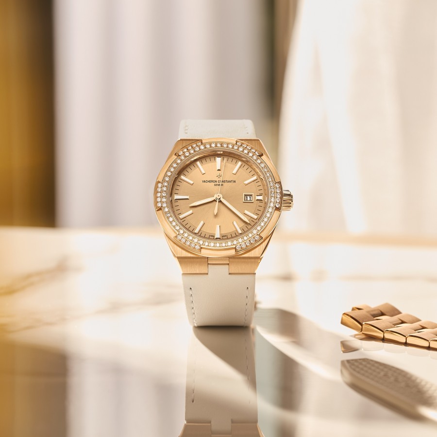 Front view of an Overseas Self-winding in pink gold with a bezel set with diamonds and a white strap