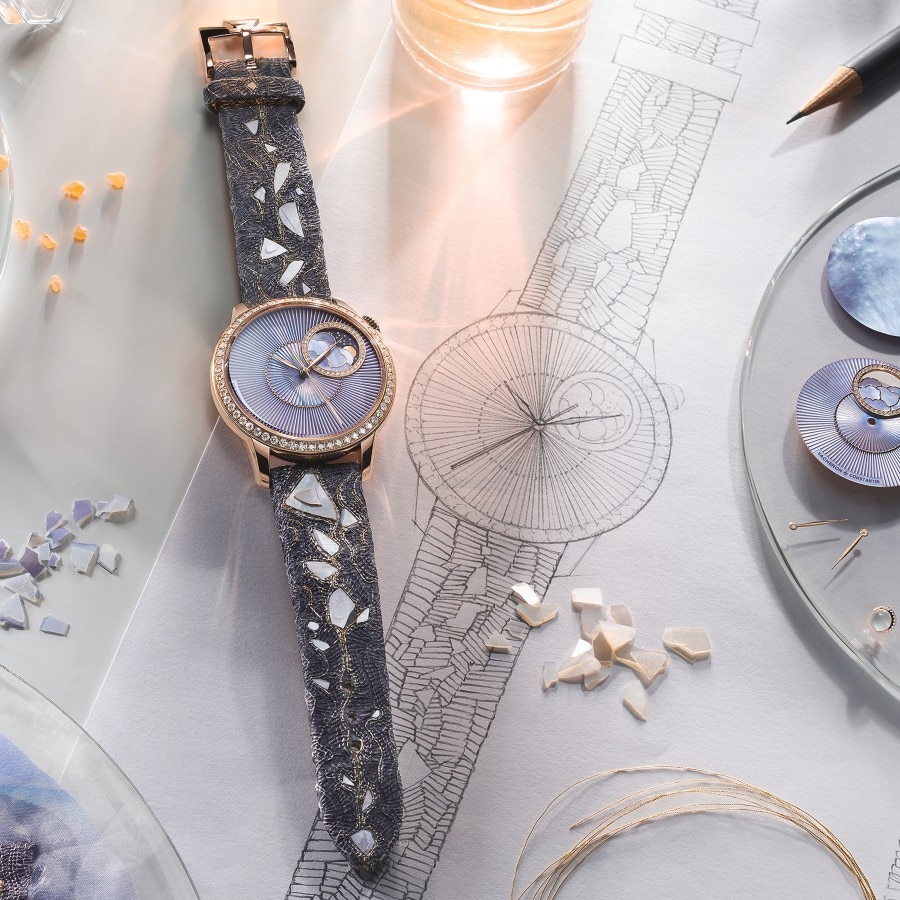 Elegant watch with a round gold frame and light purple case