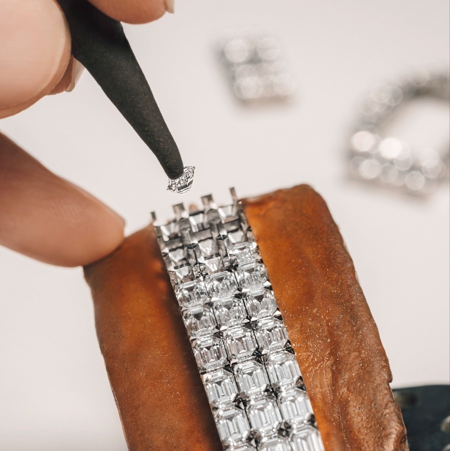 Hands creating a jewel on the wrist