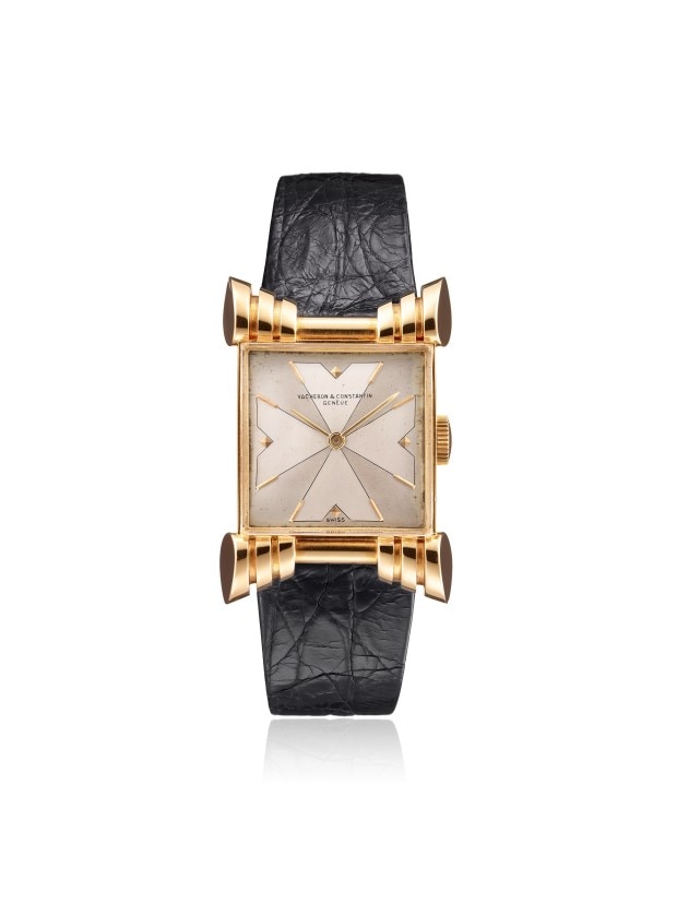 Gold rectangular wirstwatch with a black leather strap.