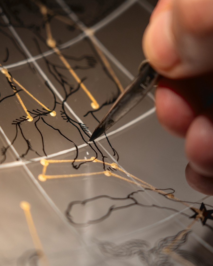 Image illustrating a hand painting a constellation