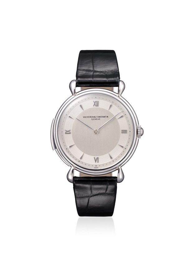 Elegant silver wirstwatch with a minimalist design and a black leather strap.