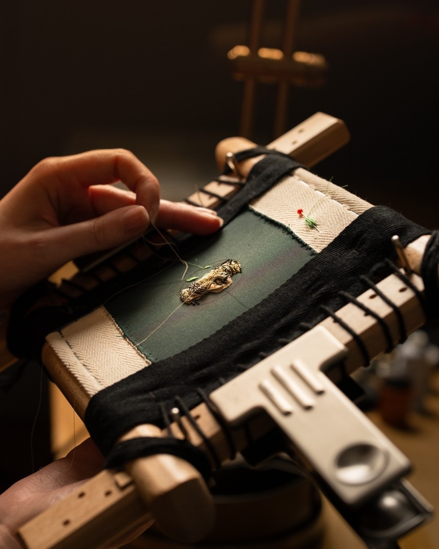 Process of sewing on the gold embroidery concept watch.