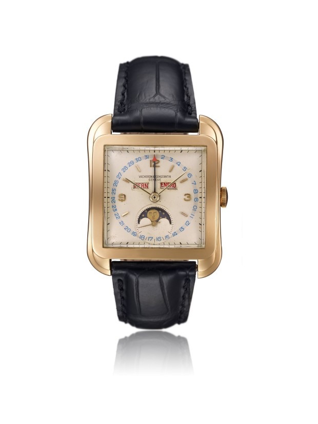 Gold rectangular wirstwatch with a moon phase complication, calendar function and a black leather strap.