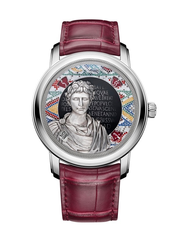 A silver wirstwatch with a burgundly leather strap, featuring a dial with a Roman-inspired design, includin a detailed bust of classical figure and Latin inscriptions.
