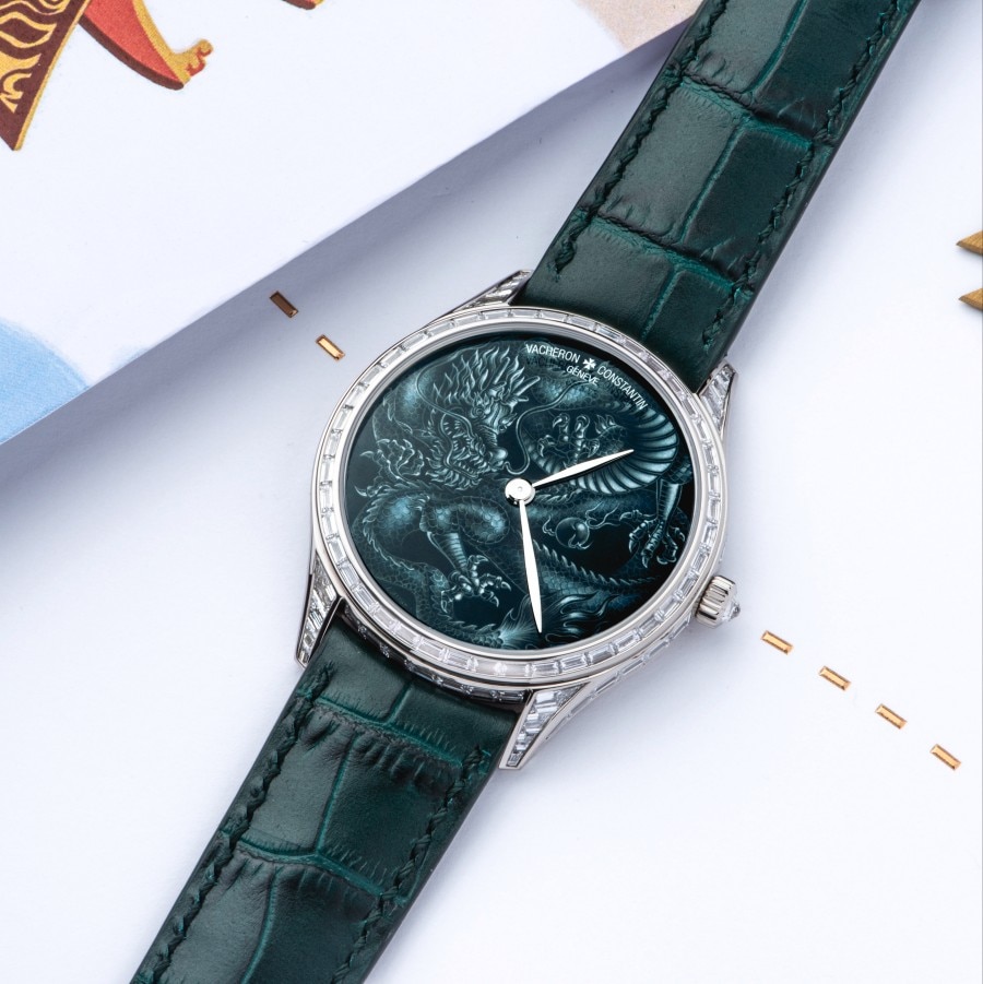 A fine watch with a dark green bracelet and silver details