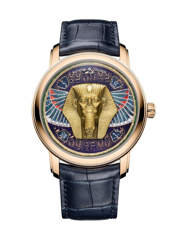 Luxurious gold wirstwatch featuring an Egyptian pharaoh design with hieroglyphics and intricate detailing.