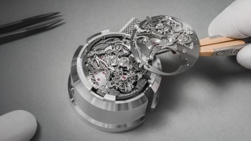 Close-up of a watch movement being assembled with precision tools.